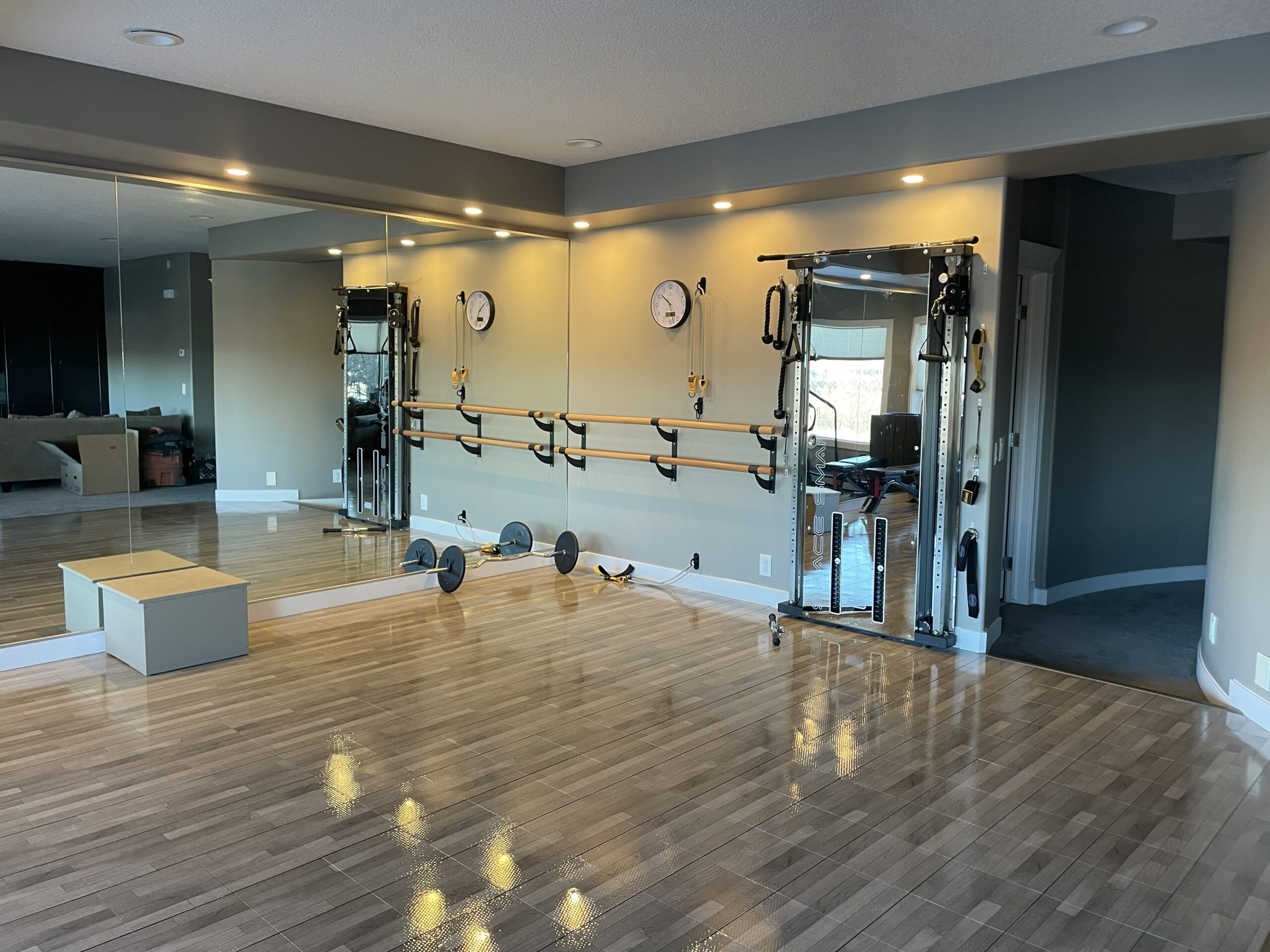 Finished Mt Douglas Cir SE home dance studio with mirrored wall and ballet bars in Calgary